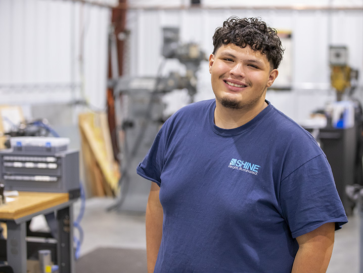 student Jacob Bernal pictured in SHINE Technologies facility