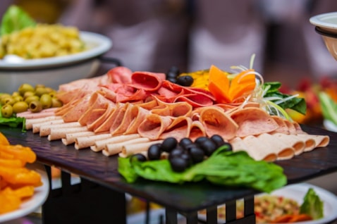 Sliced meats and cheeses on a board