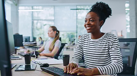 Woman looking at computer smiling