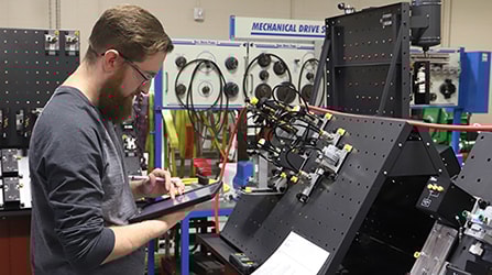 Student in manufacturing lab with tablet