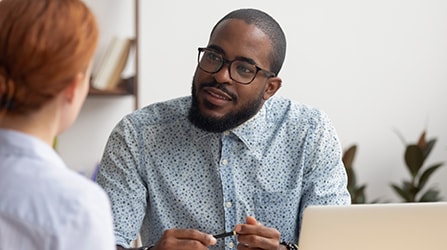 Two people in conversation with one's back turned