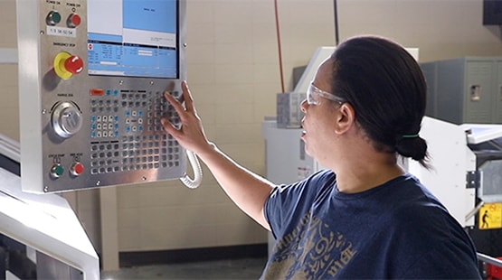 Student practicing Computer Numeric Control