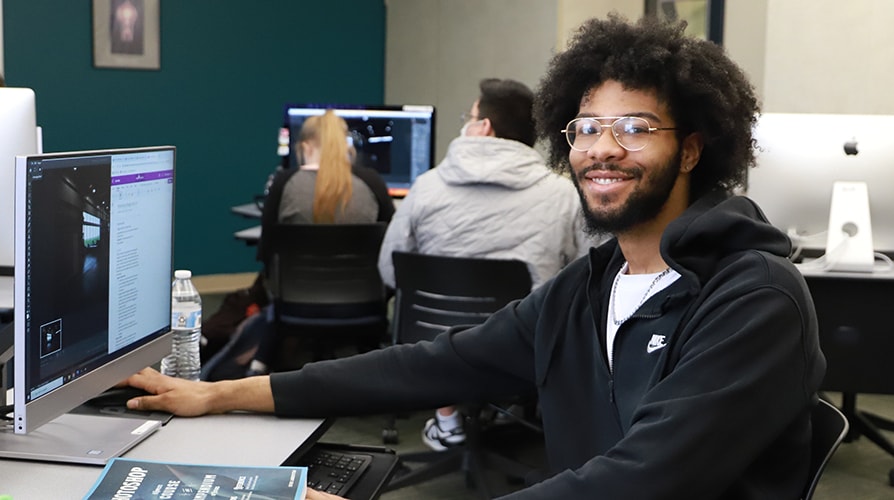 Digital Marketing student at computer in classroom