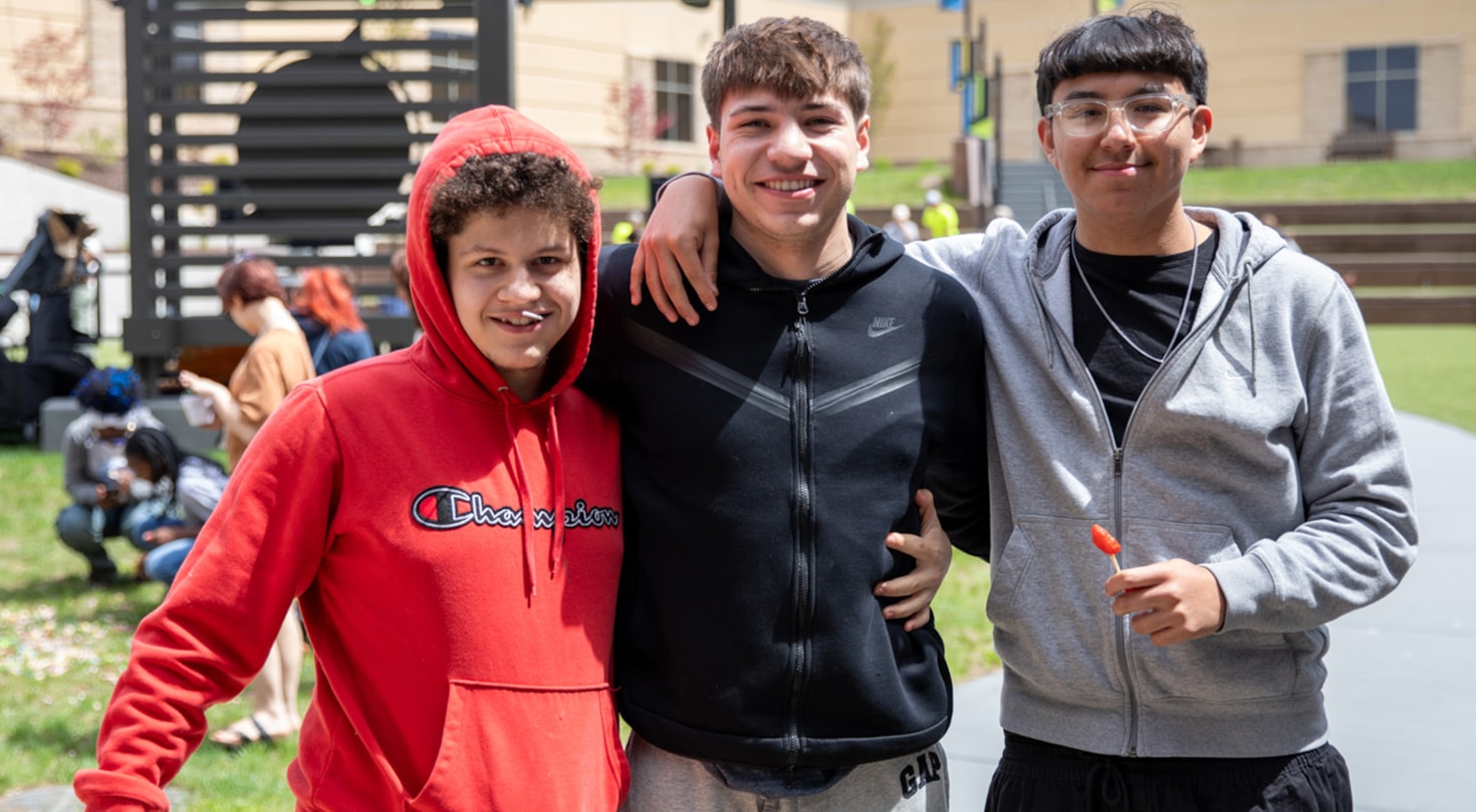 Students in the courtyard smiling at the camera during Backyard Bash celebration