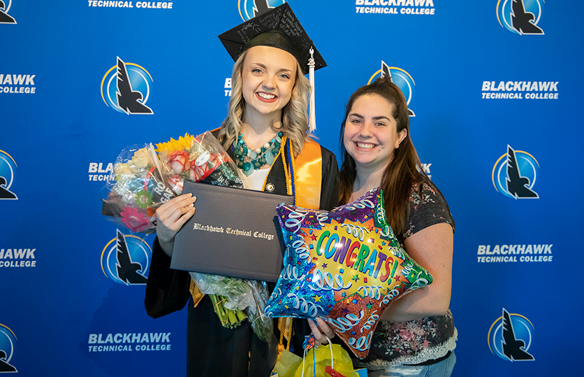 female graduate smiling with guest