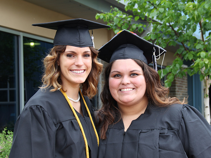 Two Graduates Smiling